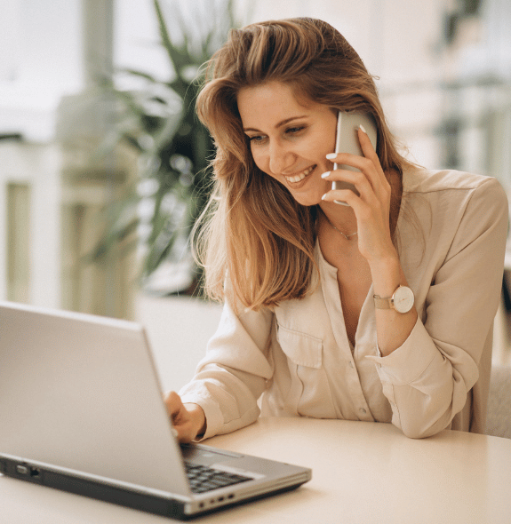 business-woman-working-laptop-talking-phone